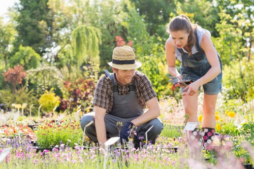 Professional gardener using tools to maintain a Westminster garden